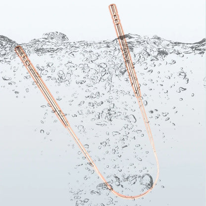Auralis tongue scraper submerged in water, showcasing its premium stainless steel design for effective tongue cleaning.